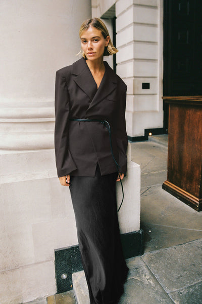 Joanna wearing CHARLI BLACK SATIN MAXI SKIRT