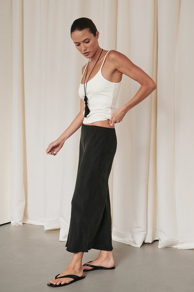 Casey wearing ARELIA BLACK CUPRO MIDI SKIRT