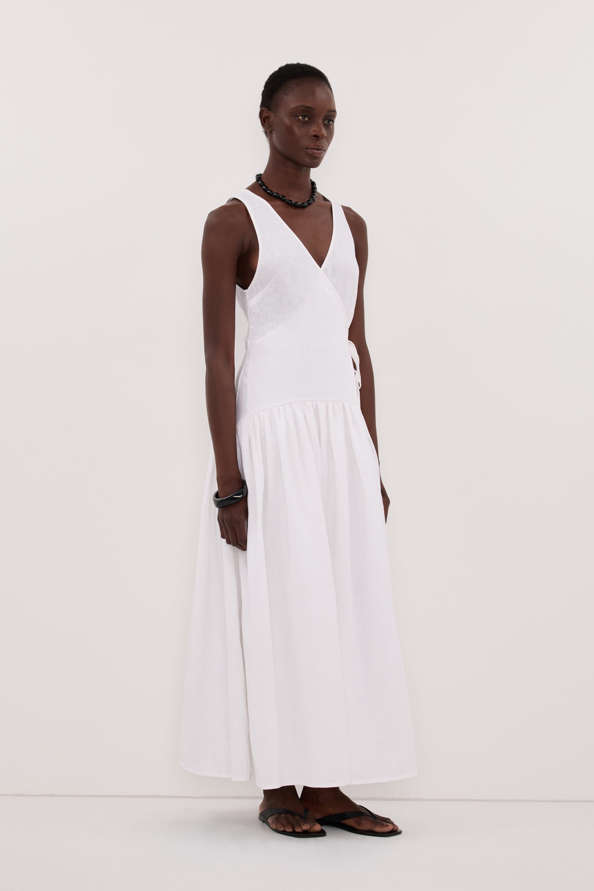 Ilio Sleeveless Linen Wrap Midi Dress in White By DISSH Ilio Sleeveless Linen Wrap Midi Dress in White By DISSH