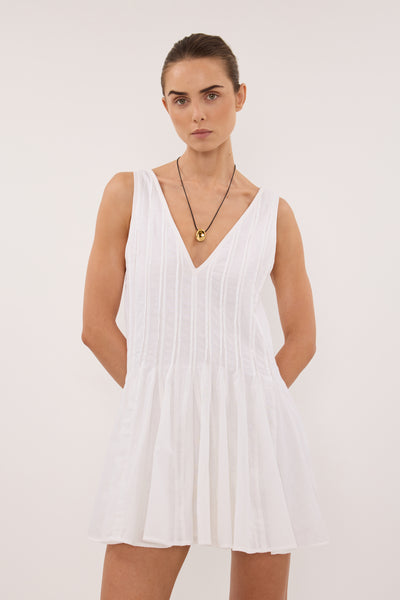 Stas wearing PIXIE WHITE LINEN MINI GODET DRESS