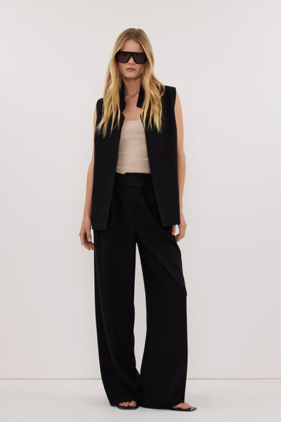 Zoe wearing VIDA BLACK STAND COLLAR VEST TOP