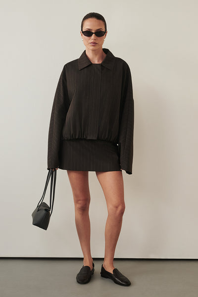 Casey wearing SIAN PEAT PINSTRIPE BOMBER JACKET