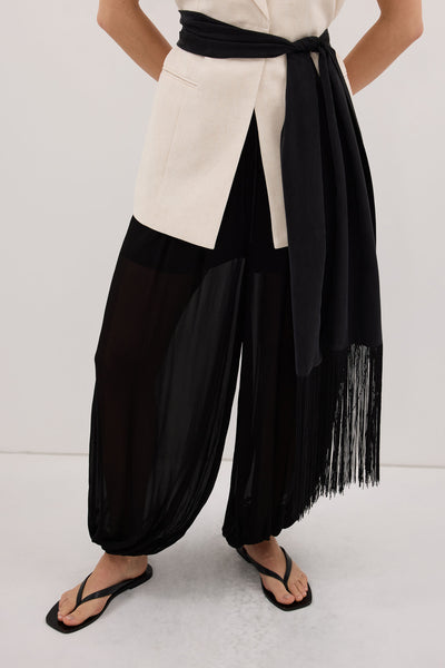 Stas wearing FIORA BLACK CUPRO FRINGE SCARF