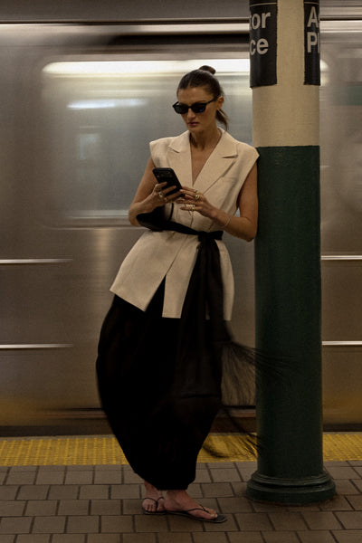 Coco wearing FIORA BLACK CUPRO FRINGE SCARF