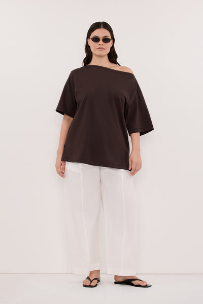 Jasmine wearing ESME BITTER CHOC ASYM BOAT NECK TEE