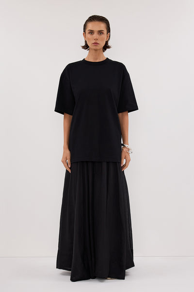 Stas wearing NOAH BLACK LONGLINE TEE