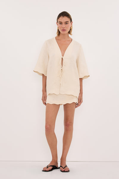 Kristen wearing LELA SANDSTONE LONG SLEEVE LINEN TOP