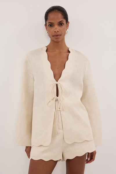 Kristen wearing LELA SANDSTONE LONG SLEEVE LINEN TOP