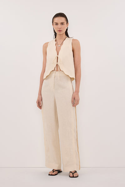Stas wearing LELA SANDSTONE SLEEVELESS LINEN VEST TOP