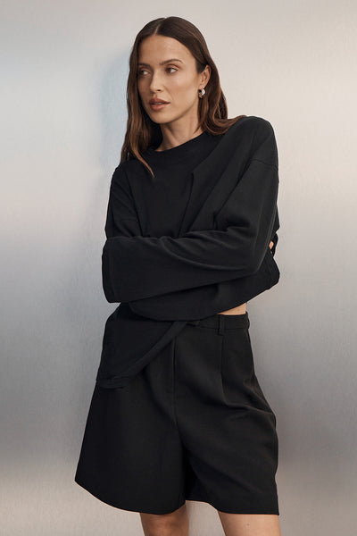 Casey wearing SLOANE BLACK LONG SLEEVE CREW KNIT TOP