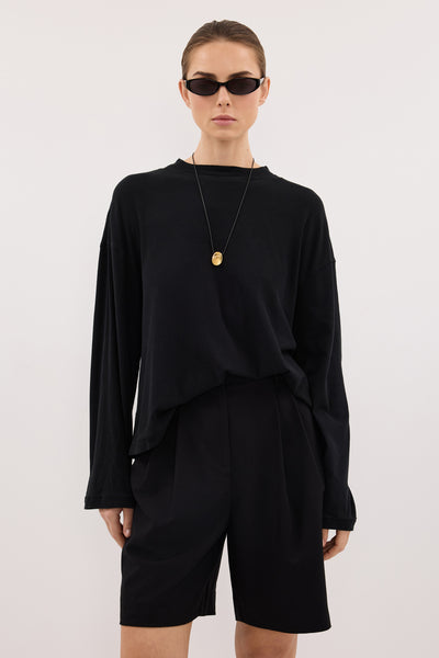 Stas wearing SLOANE BLACK LONG SLEEVE CREW KNIT TOP
