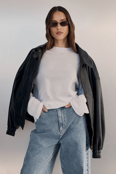Casey wearing SLOANE WHITE LONG SLEEVE CREW KNIT TOP
