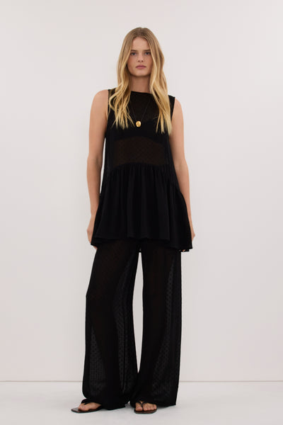 Zoe wearing SALINA BLACK DOT DROP WAIST TOP