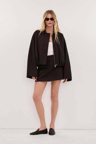 Zoe wearing SIAN PEAT PINSTRIPE TAILORED SKORT