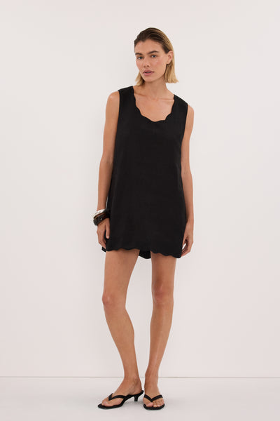 Joanna wearing LELA BLACK SLEEVELESS LINEN MINI DRESS