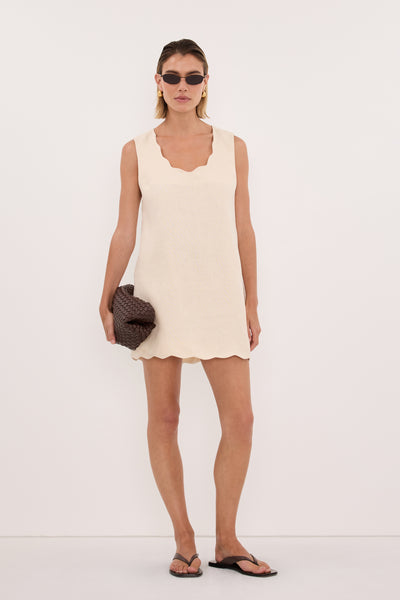 Joanna wearing LELA SANDSTONE SLEEVELESS LINEN MINI DRESS