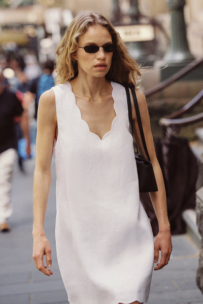 Sabine wearing LELA WHITE SLEEVELESS LINEN MINI DRESS
