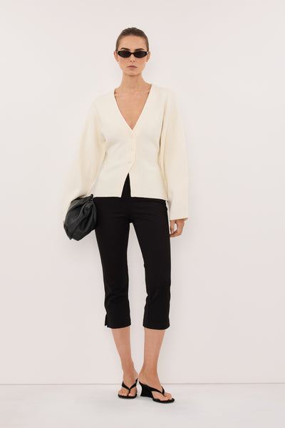 Stas wearing ISLA CREAM V NECK CARDIGAN