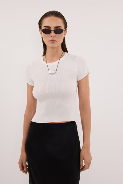 Stas wearing CLO WHITE RIBBED BABY TEE
