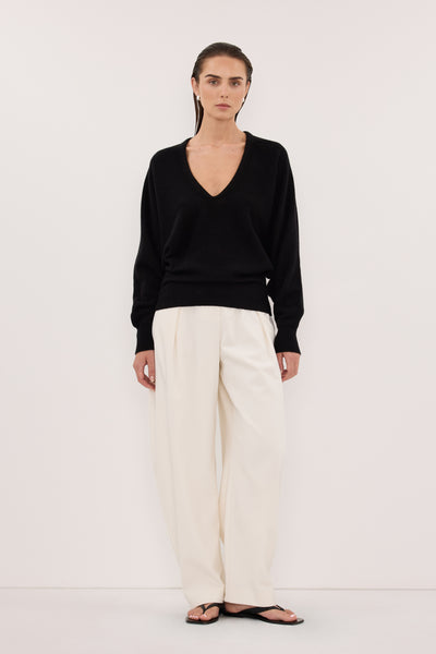 Stas wearing LUMI BLACK V NECK MERINO KNIT JUMPER