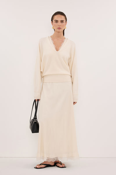 Stas wearing LUMI CREAM V NECK MERINO KNIT JUMPER